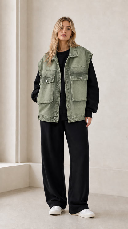 Front full view of woman wearing sage green vintage washed oversized denim vest