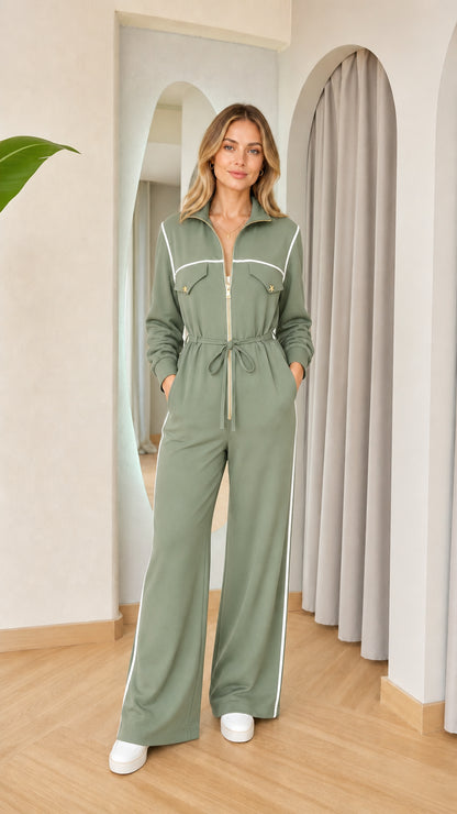 Sage green long sleeve zip-front wide leg jumpsuit with white piping and drawstring waist
