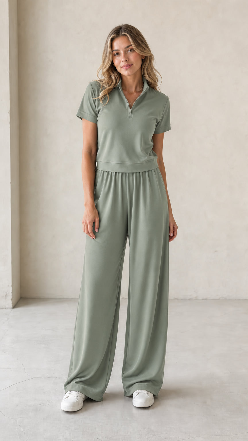 Front view of woman wearing sage green half-zip short-sleeve top and wide-leg pants set