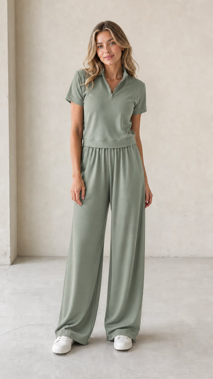 Front view of woman wearing sage green half-zip short-sleeve top and wide-leg pants set