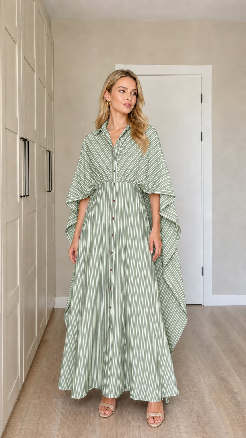 Front view of woman wearing sage green striped button-down cape maxi dress