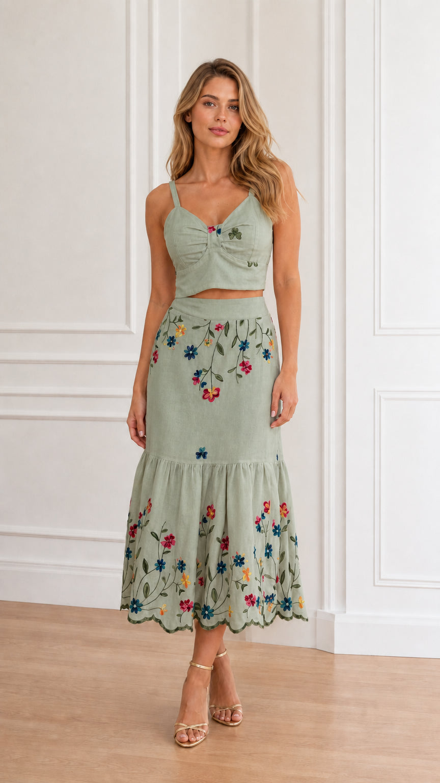 Model wearing sage green floral embroidered crop top and tiered midi skirt set