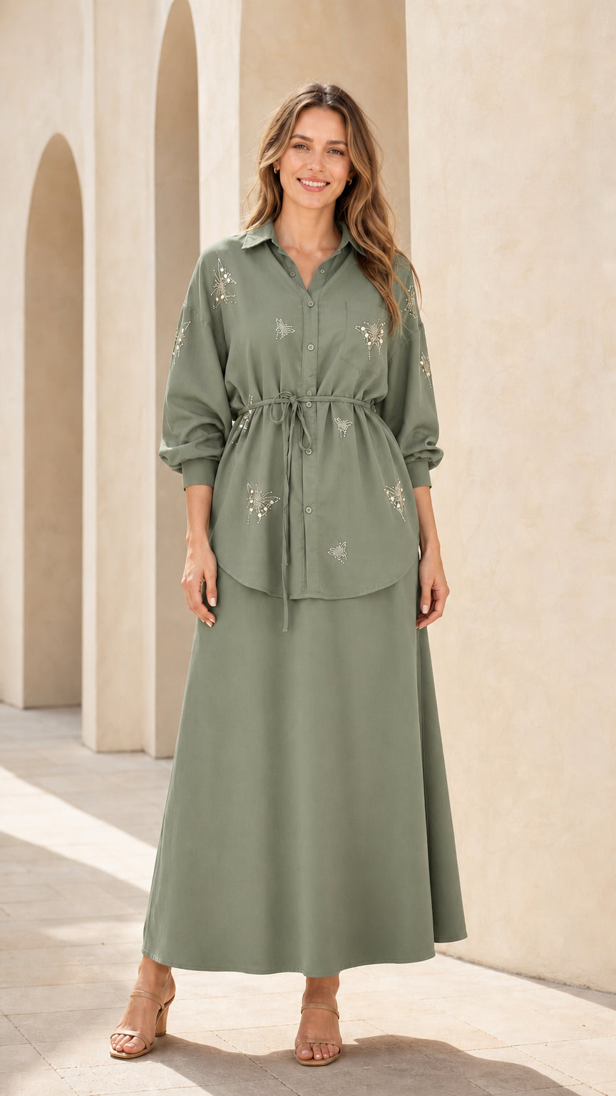 Woman wearing sage green embellished button-down tunic top and maxi skirt set