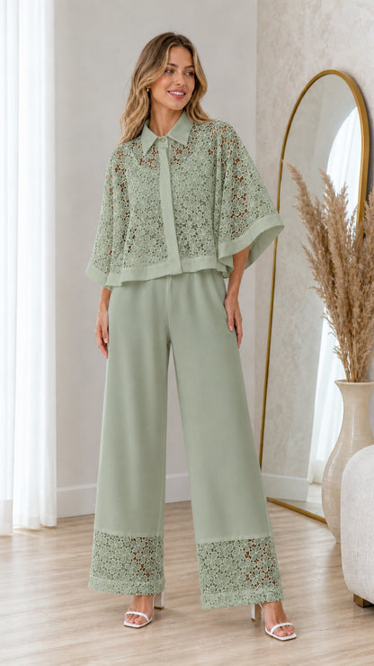Model wearing sage green lace capelet blouse and wide-leg pant set