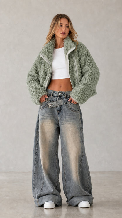 Full body studio shot of woman wearing sage green cropped teddy fleece jacket