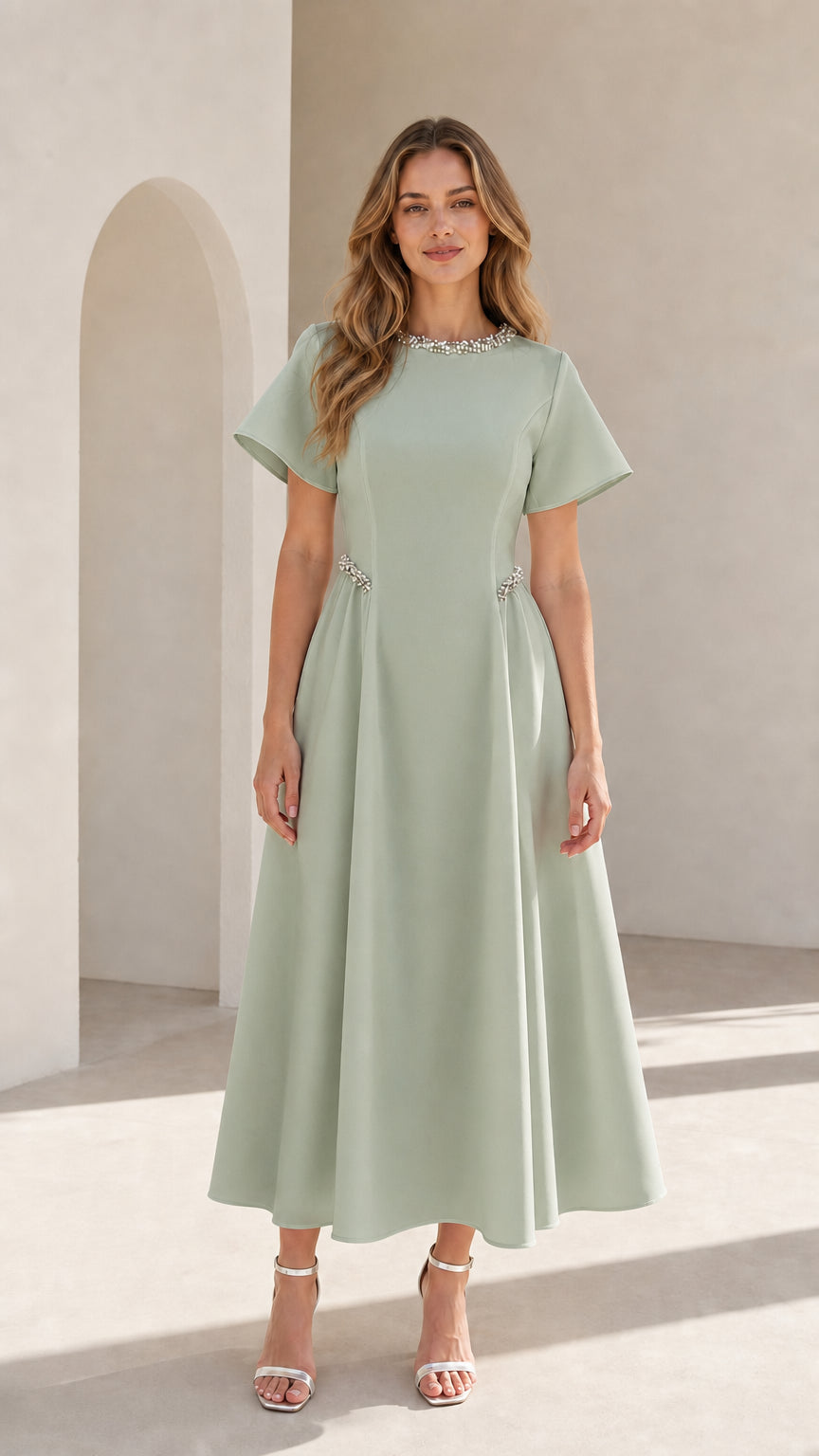 Front view of woman wearing sage green pearl embellished A-line midi dress