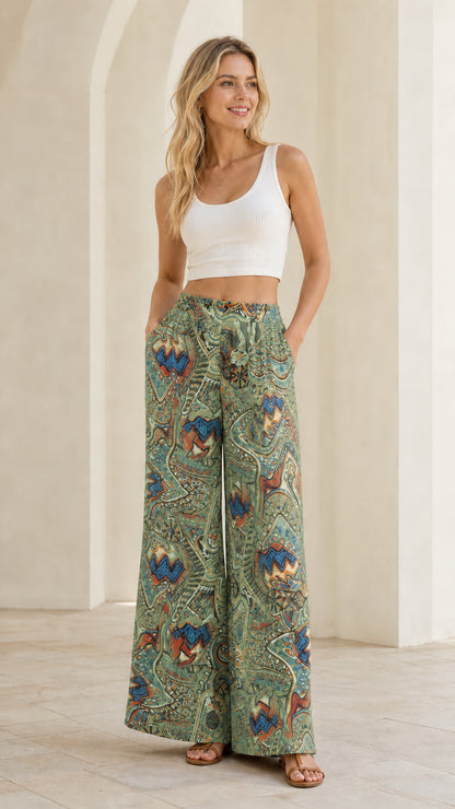Full length view of sage green multi patterned flowy wide leg trousers