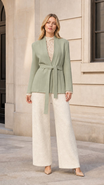 Front view of model wearing sage green belted wrap blazer jacket