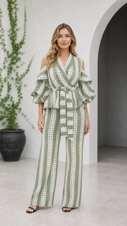 Front view of woman wearing sage green geometric cold shoulder wide-leg jumpsuit