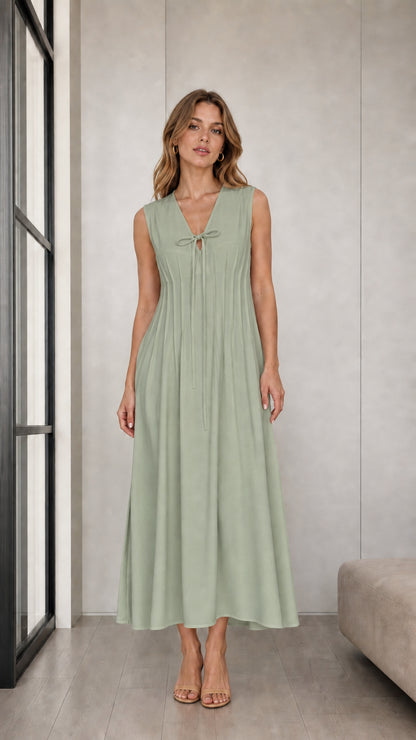 Front view of woman wearing Sage Green sleeveless pleated tie-neck midi dress