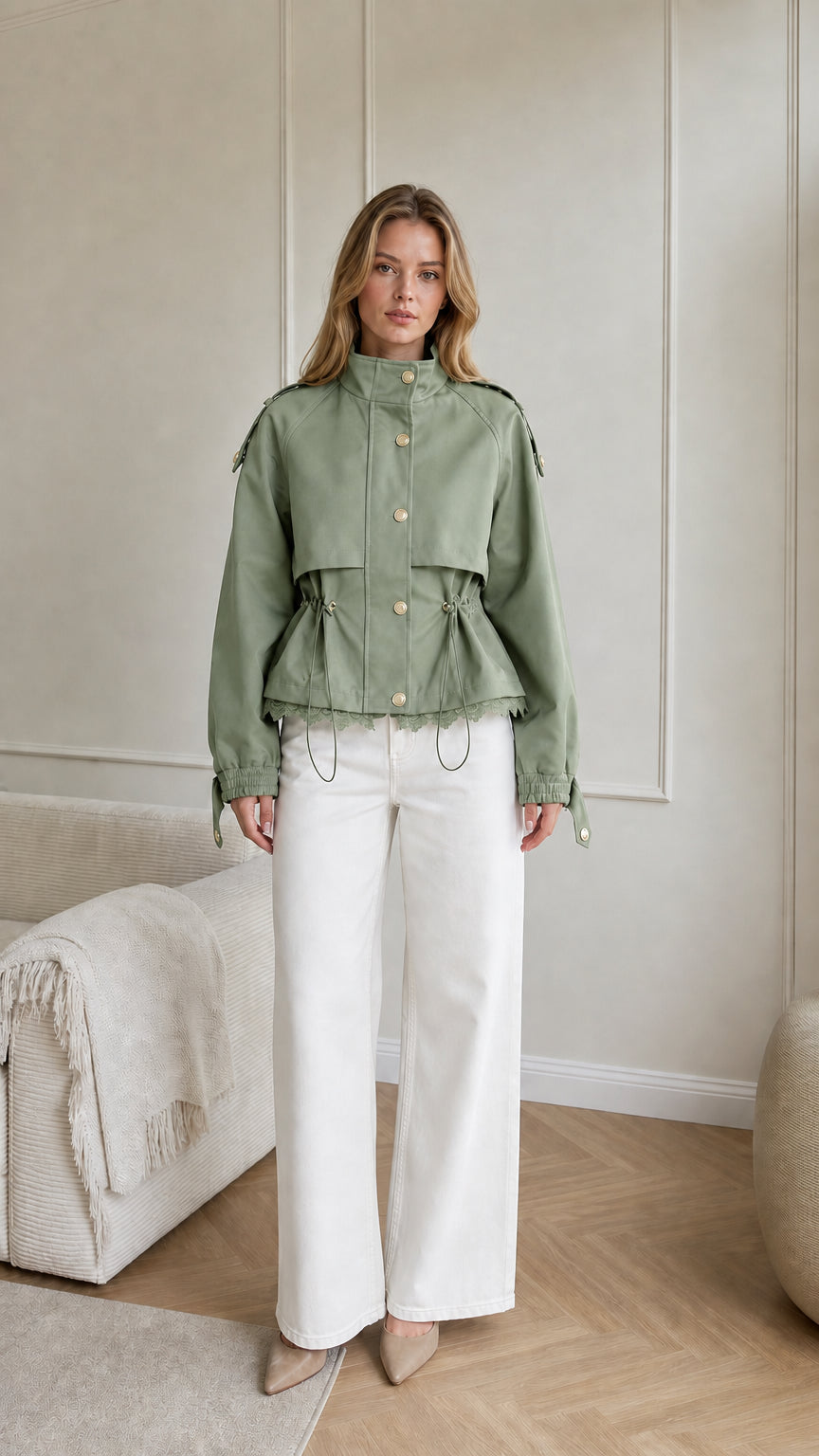Model wearing sage green cropped utility jacket with gold snap buttons