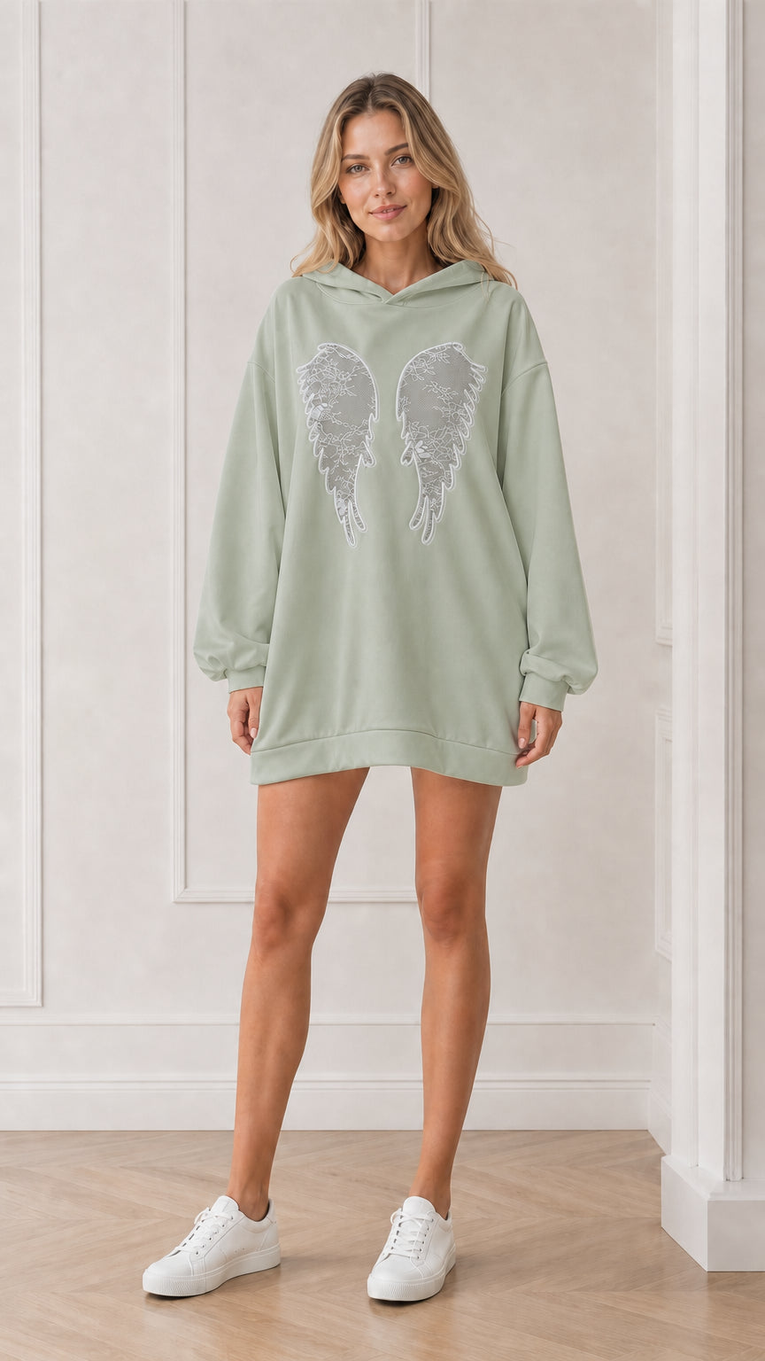 Front view of model wearing the sage green oversized angel wings hoodie dress