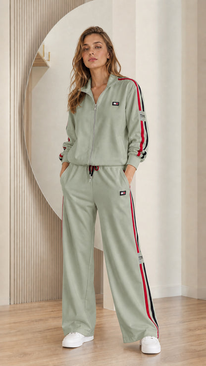 Model wearing sage green matching zip-up track jacket and pants set