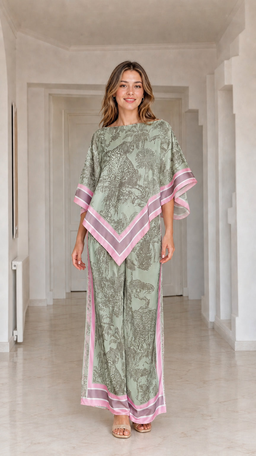 Model wearing sage green and pink printed poncho top and matching wide leg pants set