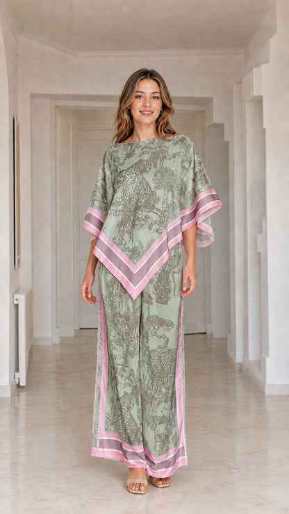 Model wearing sage green and pink printed poncho top and matching wide leg pants set