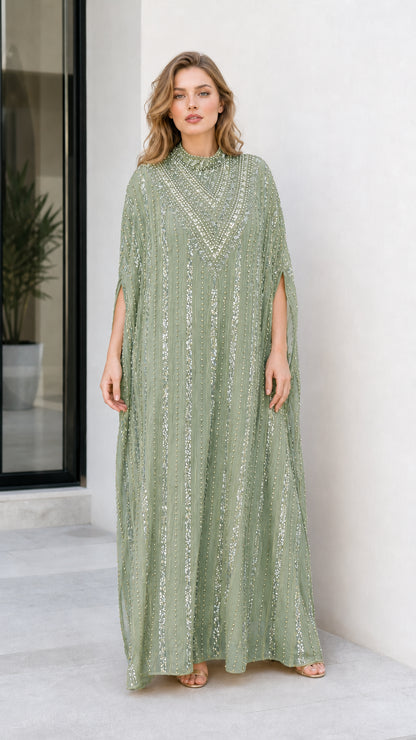Model wearing sage green embellished cape sleeve kaftan gown
