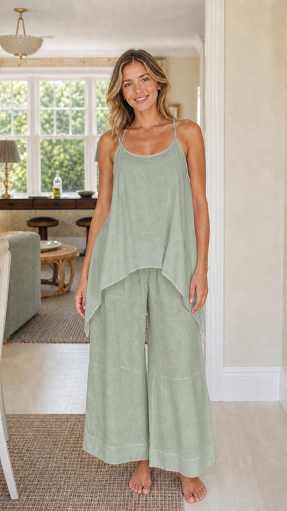 Front view of woman wearing sage green handkerchief top and wide leg pants set