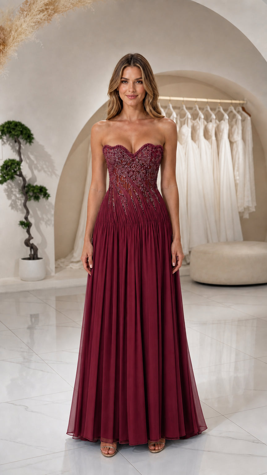 Front view of woman wearing Burgundy strapless beaded corset pleated formal dress