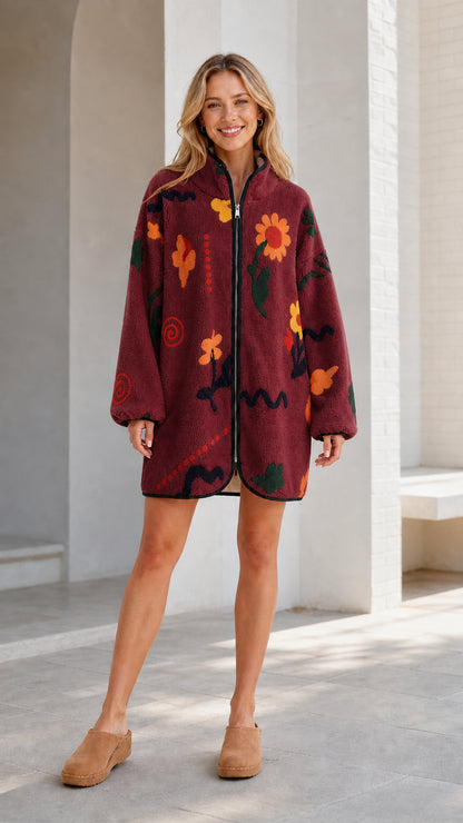 Front view of a burgundy women's floral printed fleece zip-up jacket