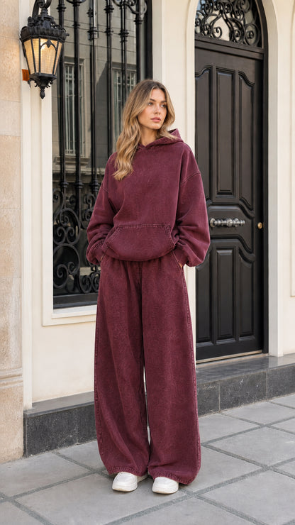 Woman wearing burgundy washed fleece hoodie and matching wide-leg tracksuit