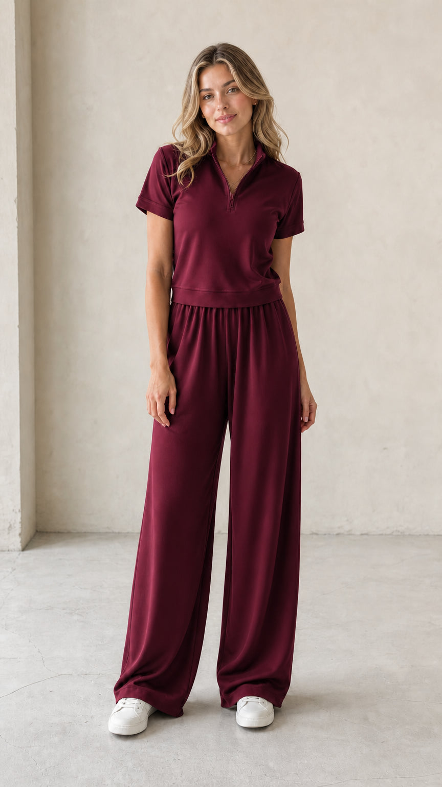 Front view of woman wearing burgundy wine half-zip short-sleeve top and wide-leg pants set