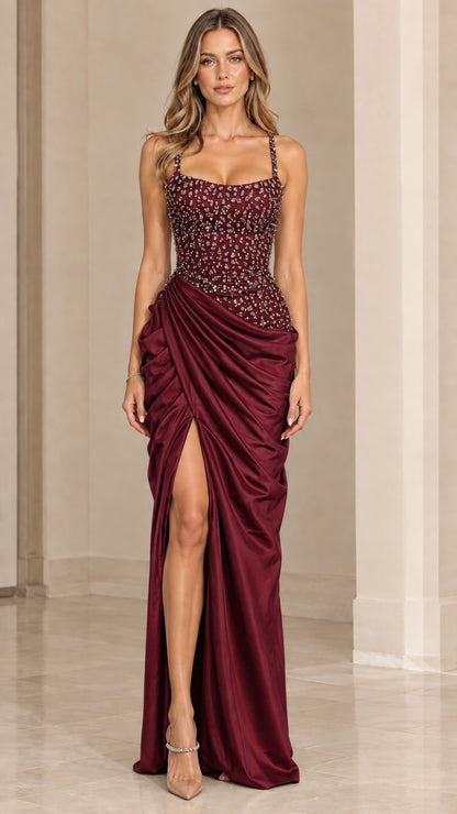 Model wearing deep burgundy red ruched satin formal dress