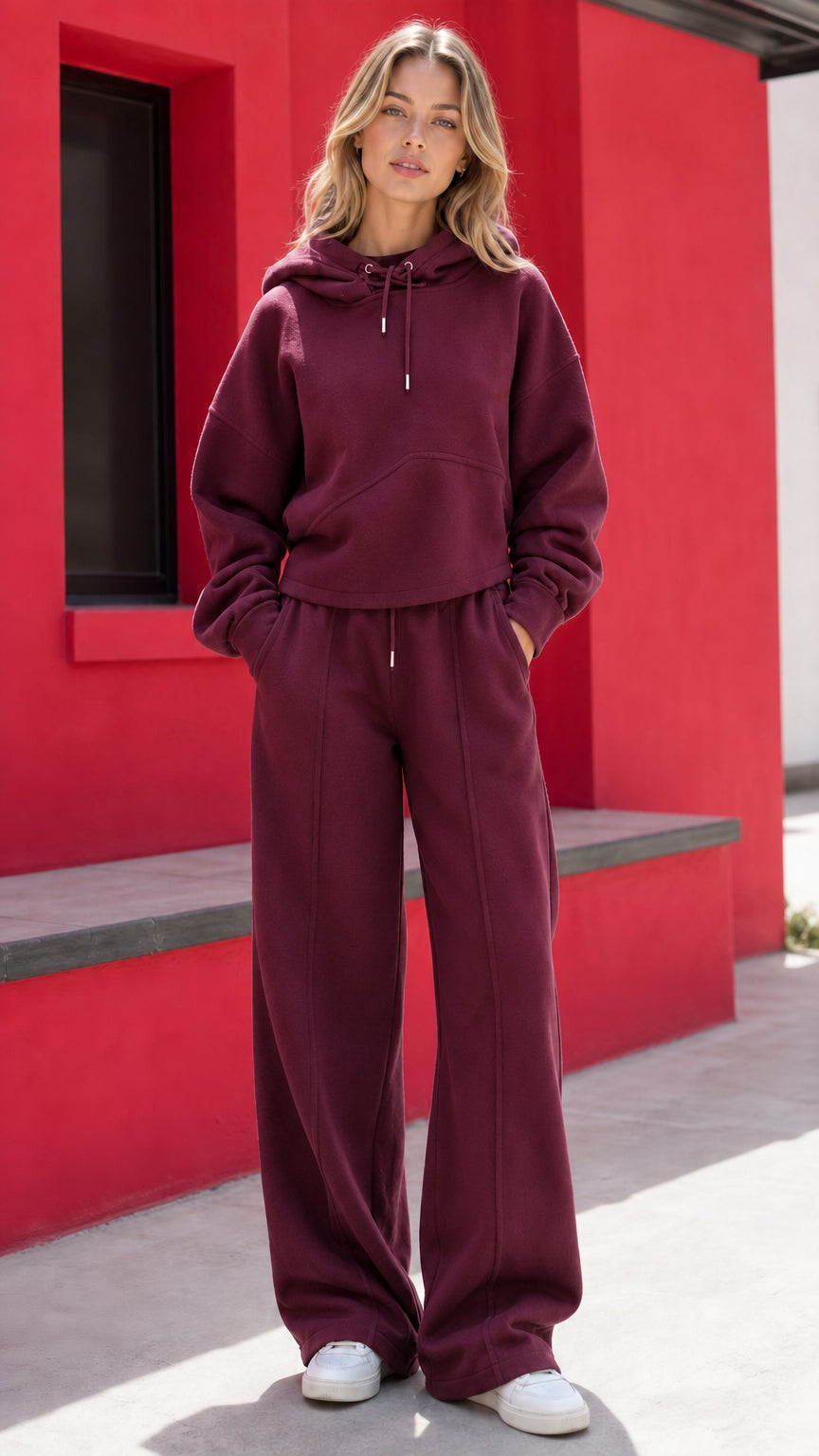 Woman wearing burgundy wine two-piece fleece hoodie and wide-leg pants set