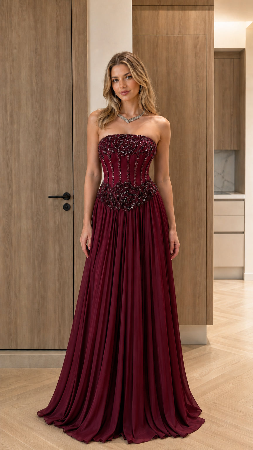 Model wearing burgundy wine red strapless beaded corset maxi dress
