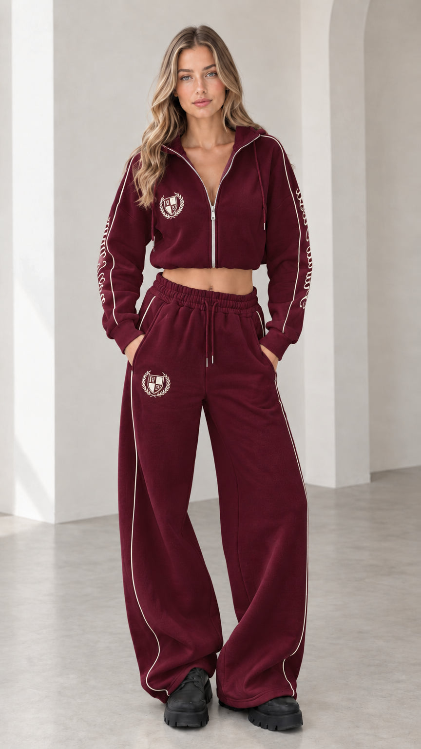 Front view of model wearing burgundy cropped hoodie and wide-leg sweatpants tracksuit set