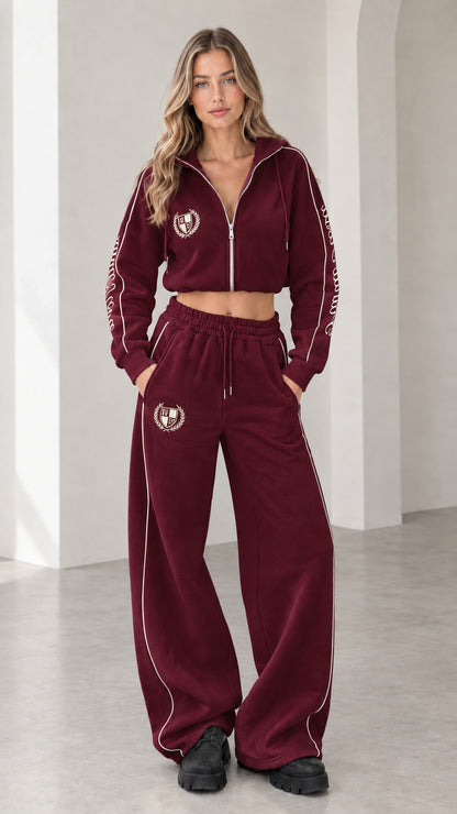 Front view of model wearing burgundy cropped hoodie and wide-leg sweatpants tracksuit set