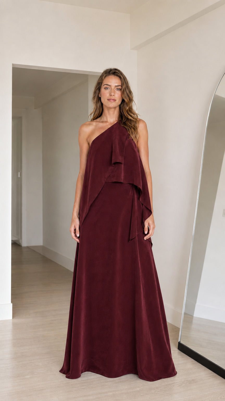 Model wearing burgundy wine red one-shoulder tiered evening gown