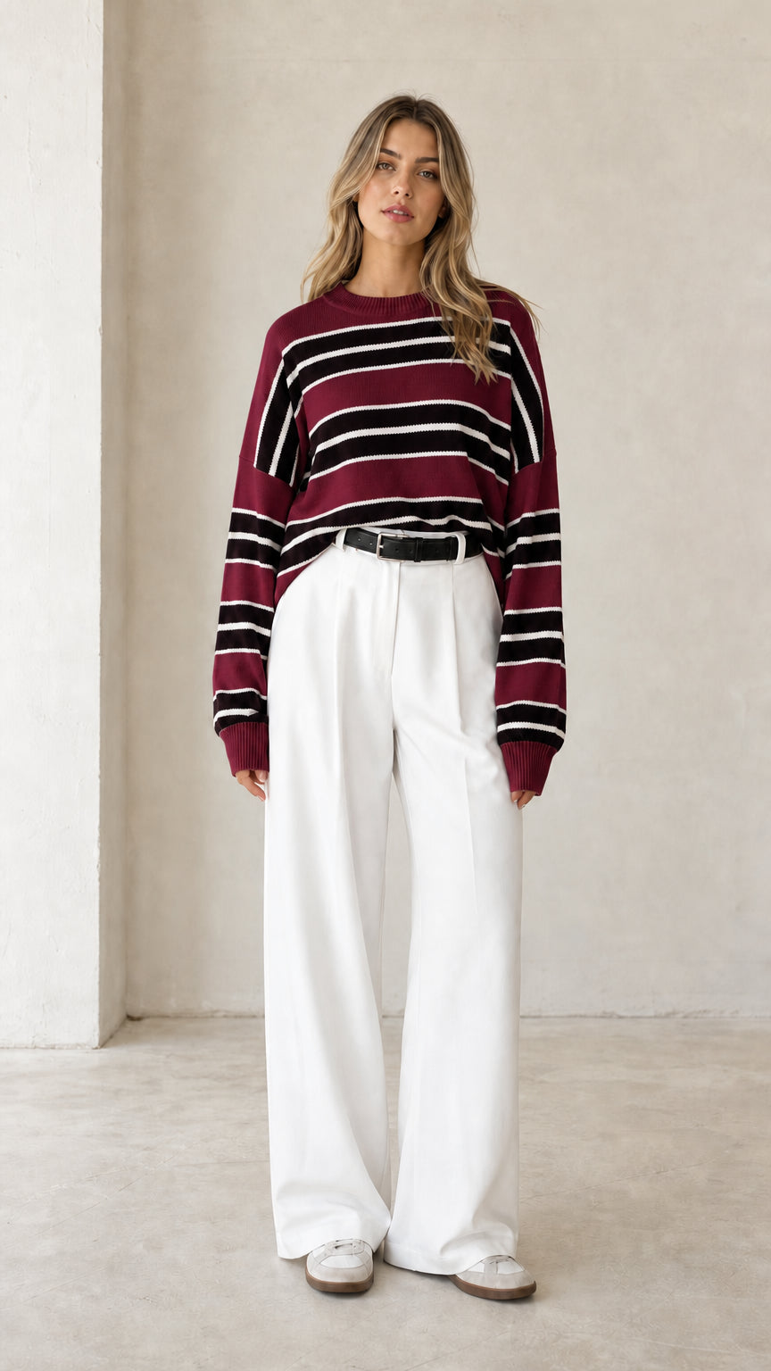 Front view of woman wearing burgundy wine red striped crewneck knit sweater