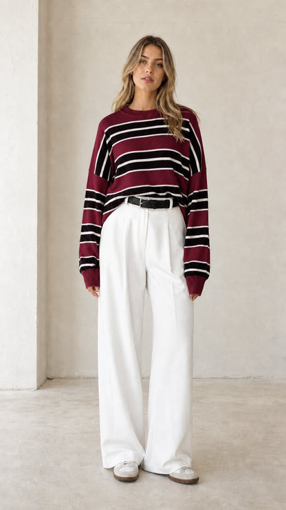 Front view of woman wearing burgundy wine red striped crewneck knit sweater