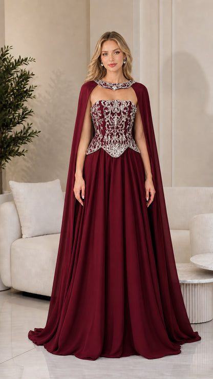 Front view of burgundy red formal gown with sparkling corset and cape