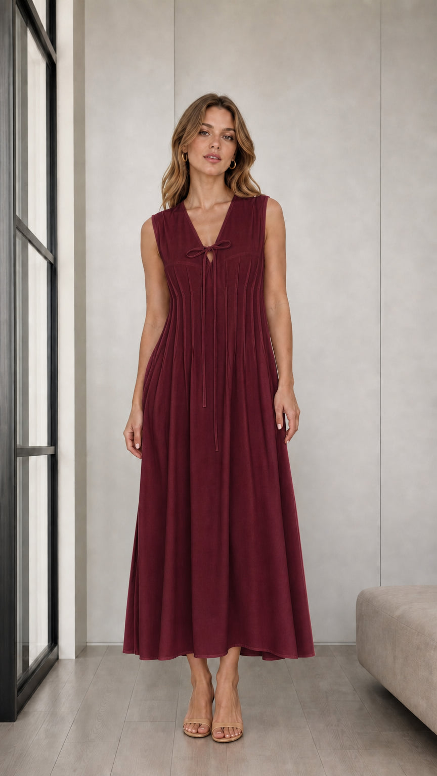 Front view of woman wearing Burgundy sleeveless pleated tie-neck midi dress