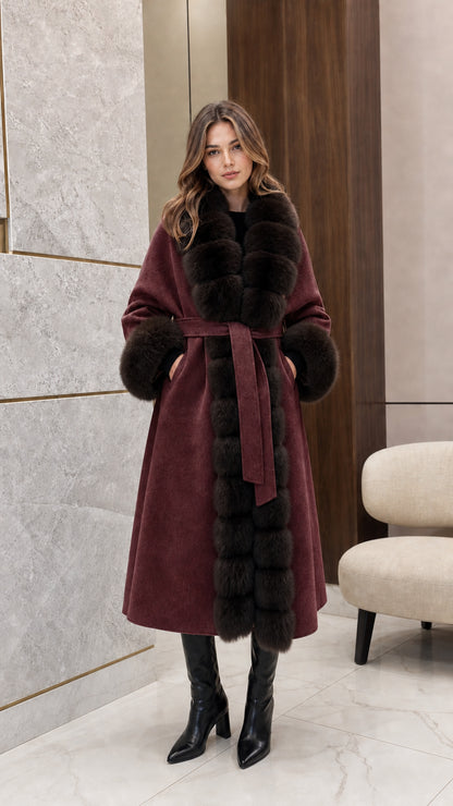Front view of woman wearing the rich burgundy belted longline coat with dark fur trim