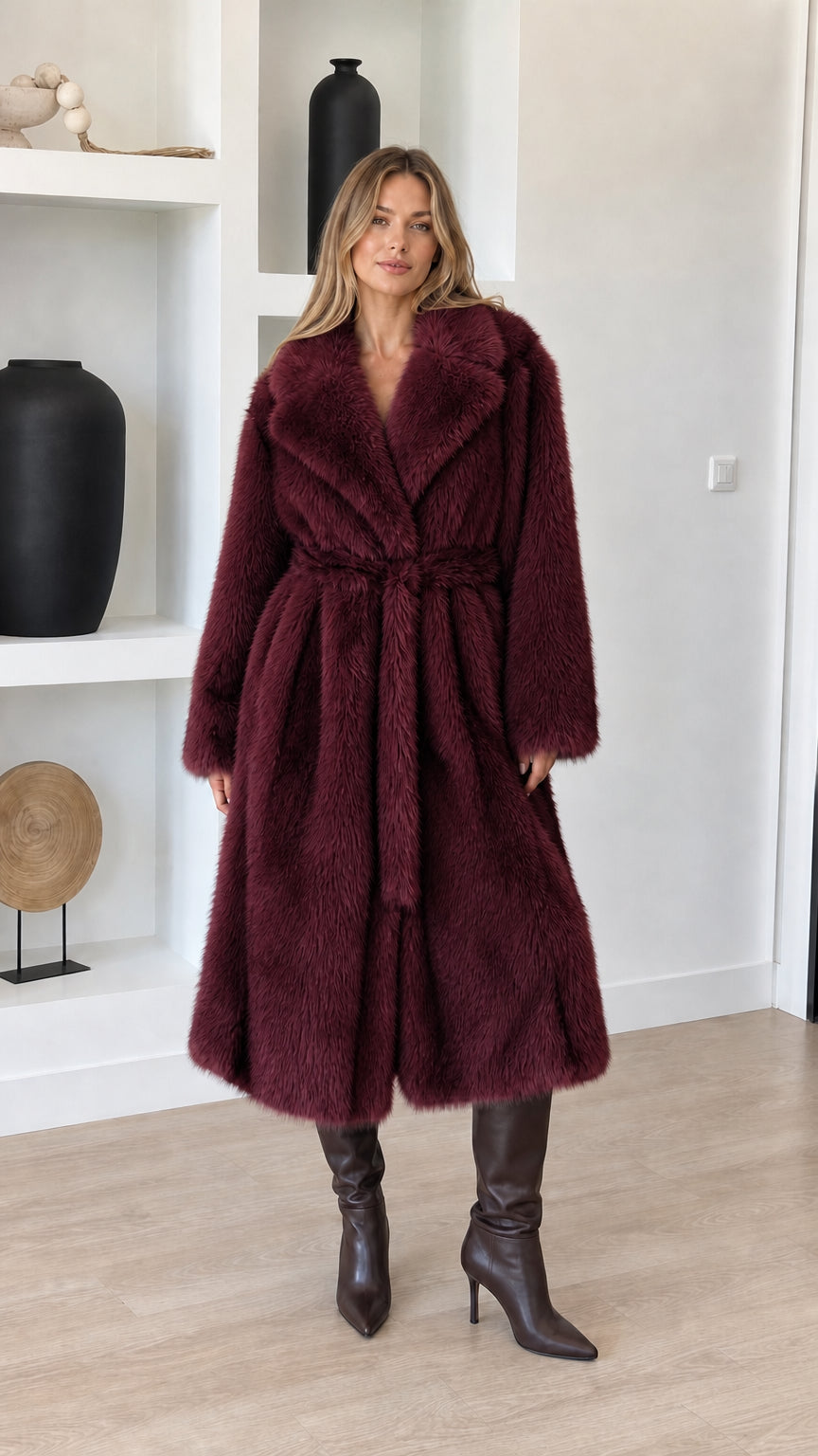 Full-length view of model wearing rich burgundy wine faux fur belted long coat