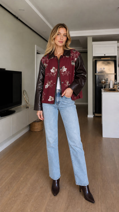 Full-body front view of model wearing burgundy floral embroidered contrast sleeve jacket