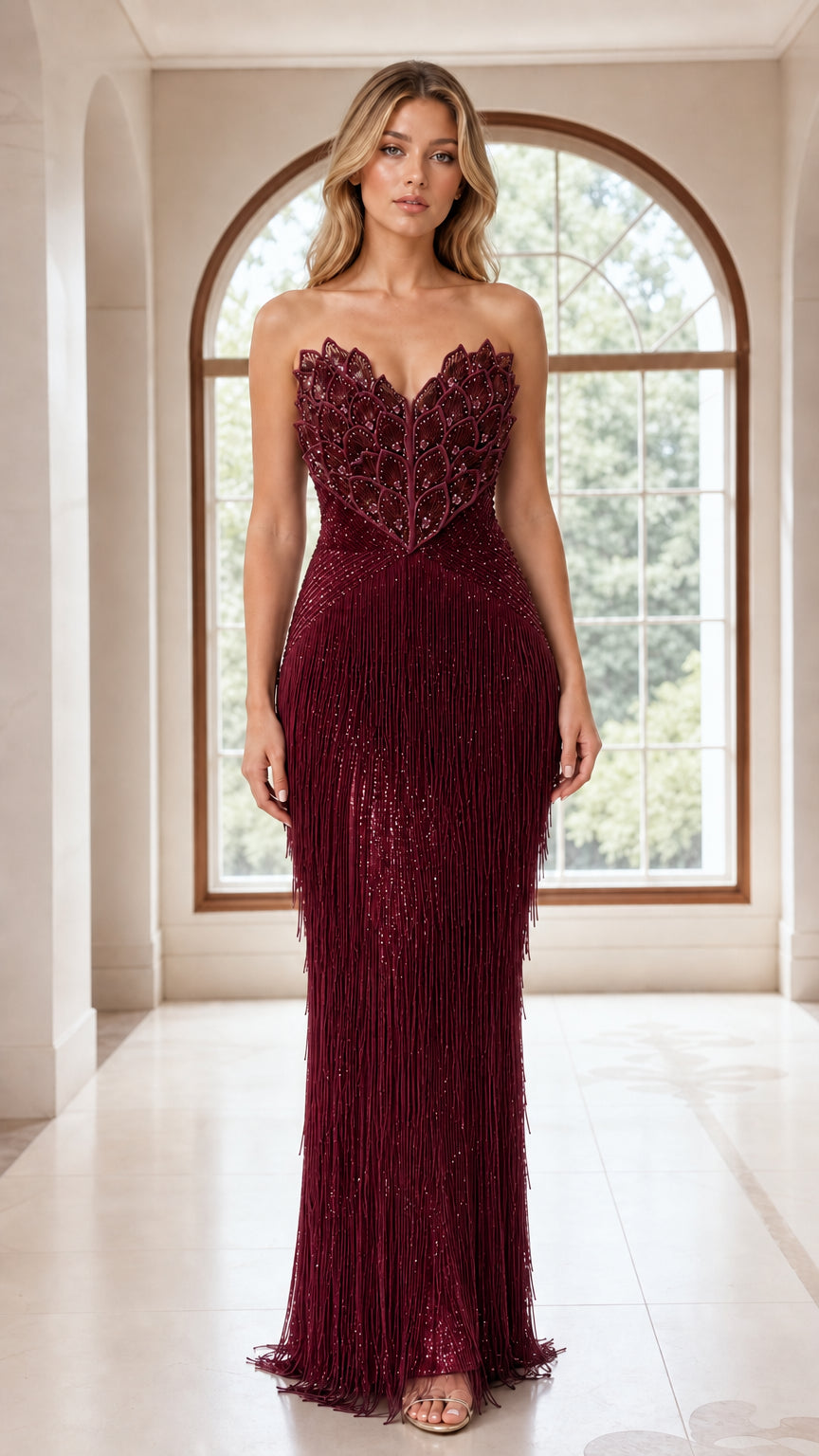 Model wearing burgundy wine red strapless beaded fringe evening dress