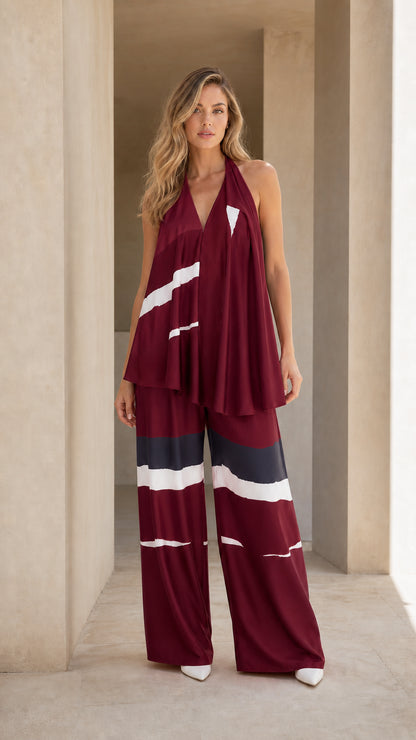 Full-length studio shot of burgundy, navy, and white color block halter wide-leg set