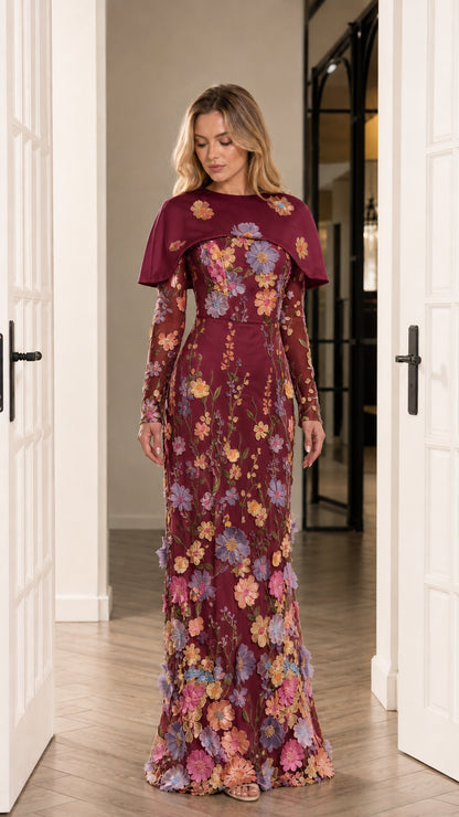 Front view of burgundy red embroidered long sleeve evening gown with capelet collar
