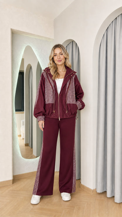 Front full-length view of model wearing the rich burgundy sequin embellished tracksuit set