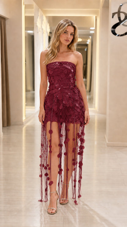 Model wearing wine red strapless sequin fringe evening dress