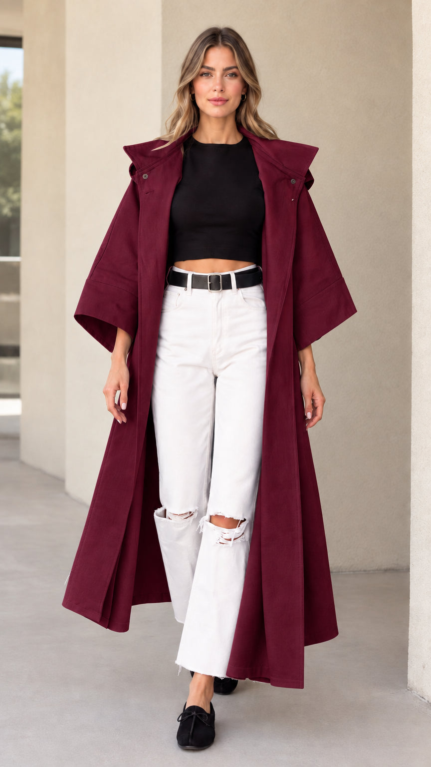 Front view of woman wearing burgundy hooded maxi duster coat