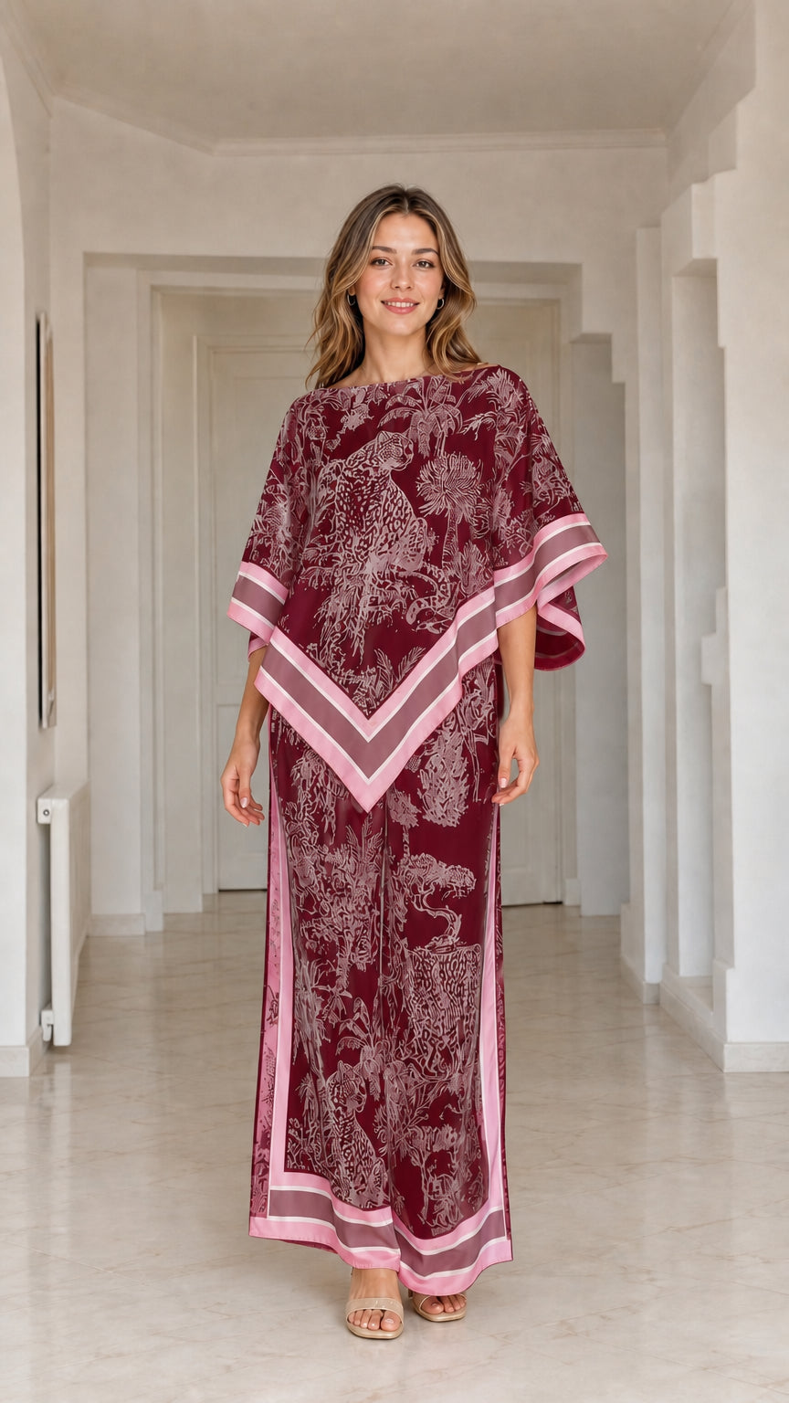 Model wearing burgundy red and pink printed poncho top and matching wide leg pants set