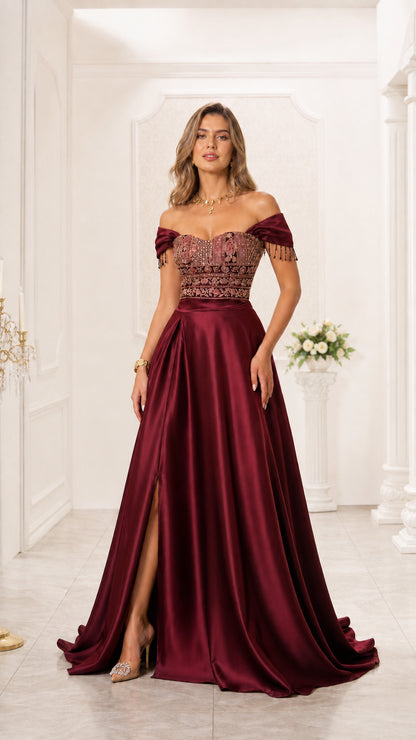 Model wearing burgundy red off-the-shoulder embroidered bodice satin evening gown with slit