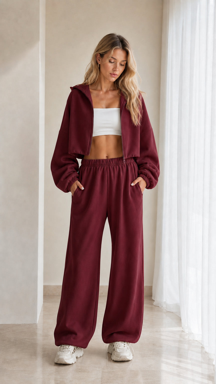 Model wearing burgundy red 2-piece cropped hoodie and wide leg sweatpants set