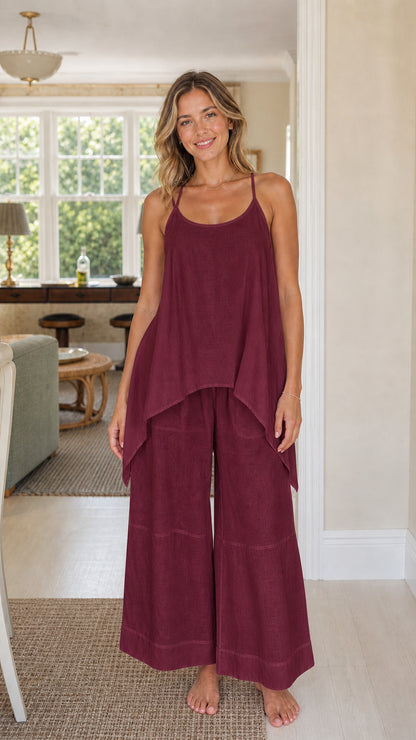 Front view of woman wearing burgundy wine handkerchief top and wide leg pants set