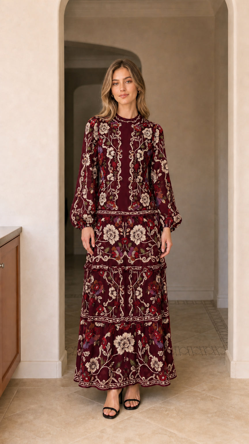 Model wearing long sleeve tiered floral maxi dress in burgundy wine
