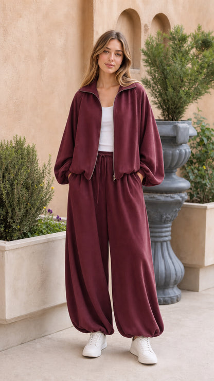 Full-body view of woman wearing burgundy 2-piece fleece tracksuit set